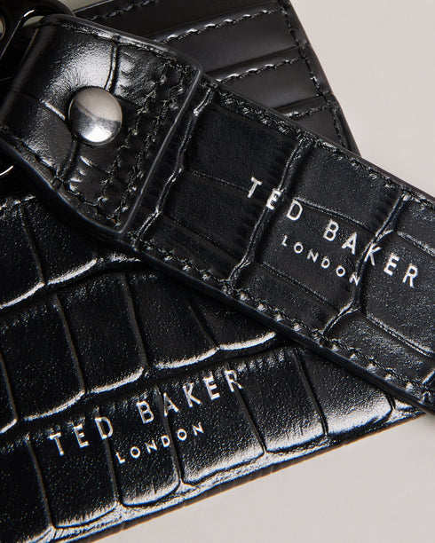 ROMAIIN-Gifts-Keep your keys and cards organized with our ROMAIIN set. Made from high-quality leather featuring a sophisticated croc texture, these accessories are the epitome of understated luxury. With a glossy finish that catches the eye, this set not only keeps your essentials in check but also adds a stylish edge to your everyday carry. Key fob and card holder set Leather Croc texture Hinge clip Logo detail Glossy finish- Ted Baker Romania